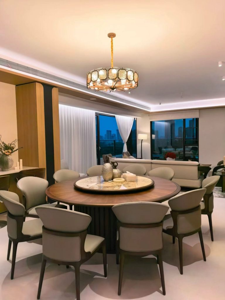 Round solid black walnut dining table with marble lazy Susan and ten upholstered chairs in a Guangdong villa