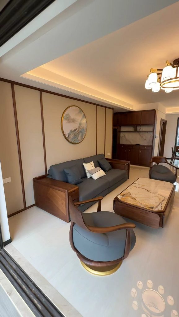 Bespoke walnut sofa paired with sculptural swivel accent chairs on brass bases in a modern Chinese living room