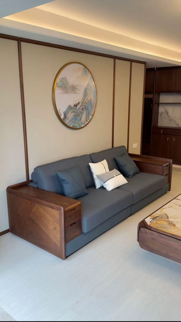 Custom black walnut sofa with integrated storage armrests and decorative pillows in a villa living room
